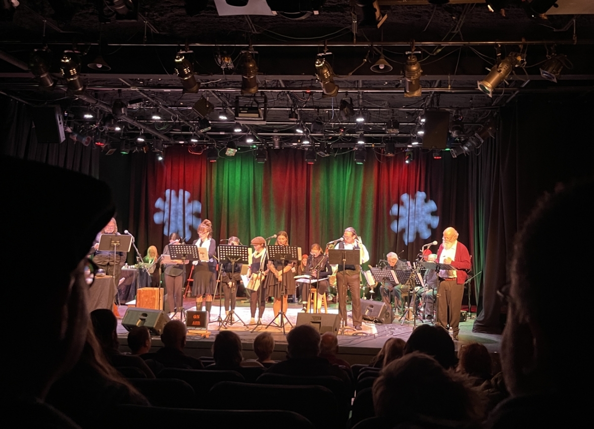 image of actors on a stage with microphones